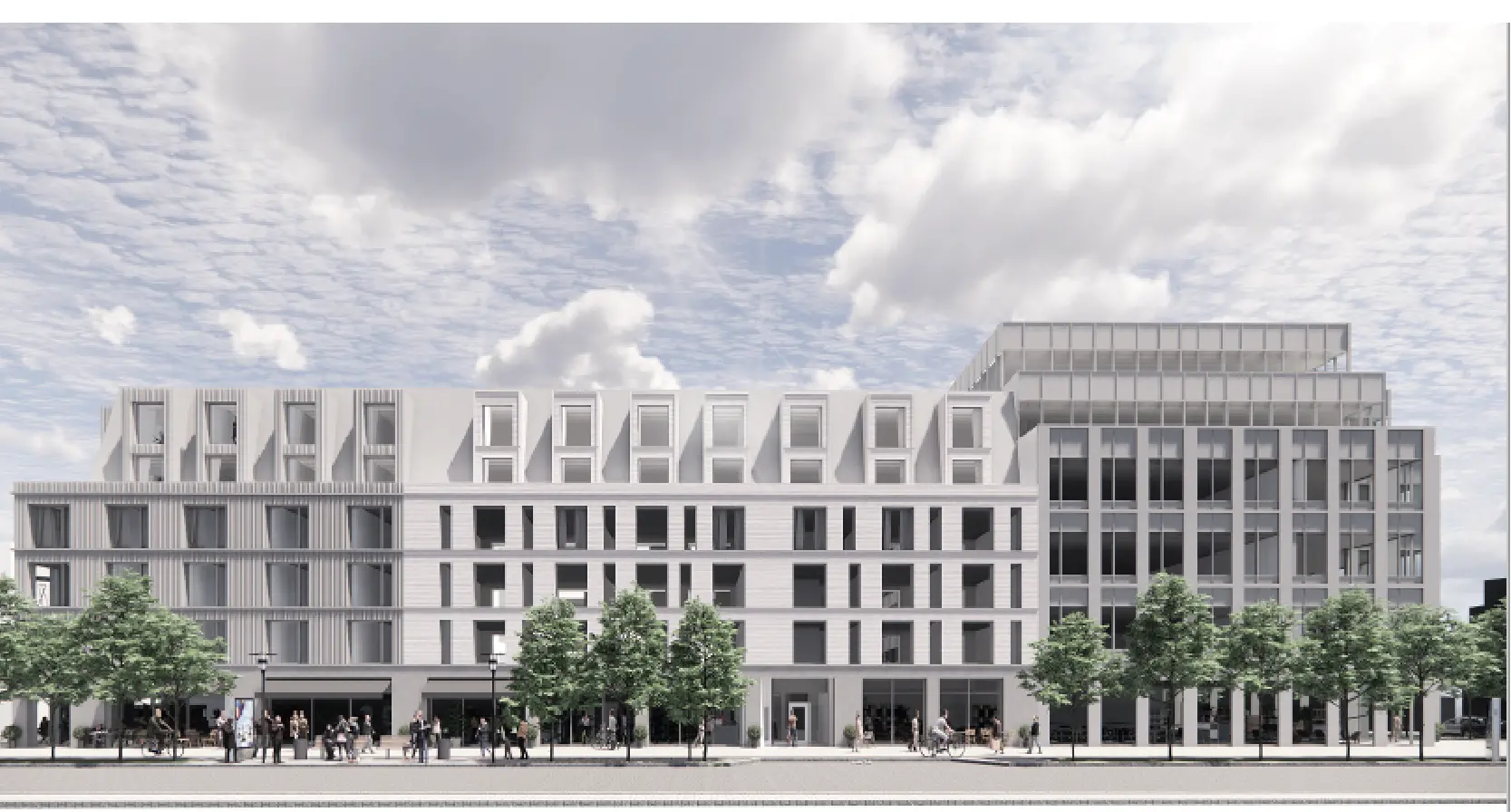 Stor vit kontorsbyggnad med träd framför byggnaden.