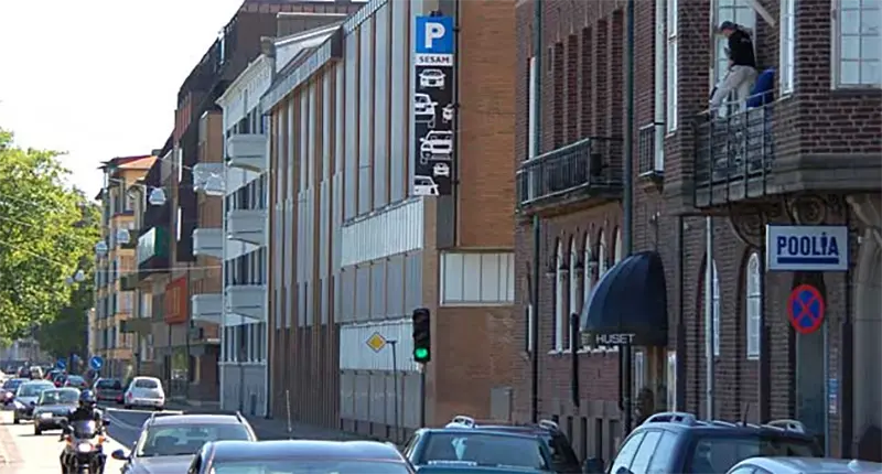 Tegelfasad med en parkeringsskylt.