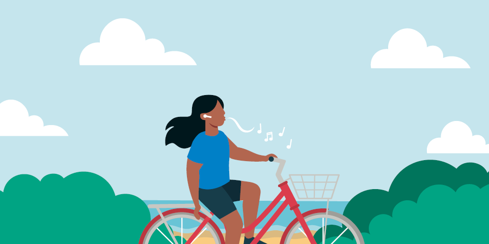illustration av en person med långt svart hår som cyklar på en röd cykel vid buskar och strand.